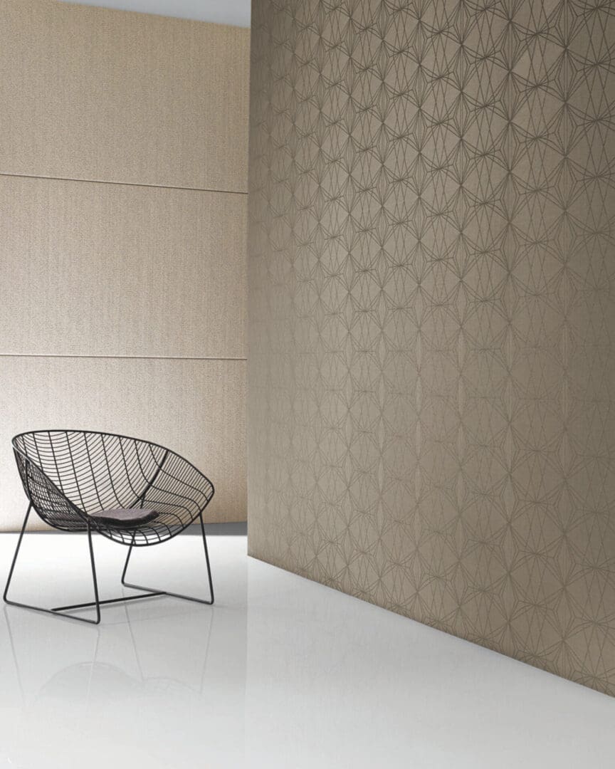 A chair in front of a wall with geometric designs.