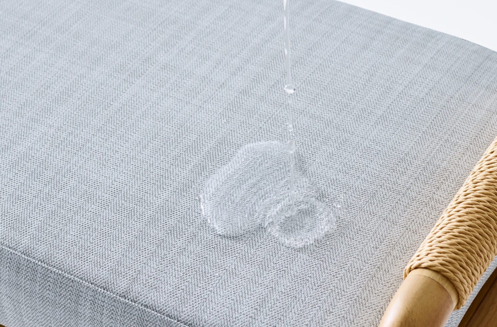 A water drop falling on top of a mattress.