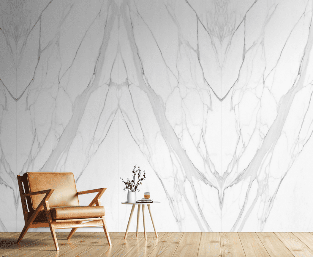 A chair and table in front of a wall with marble pattern.