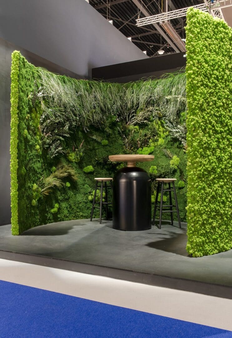A room with green walls and plants on the wall.