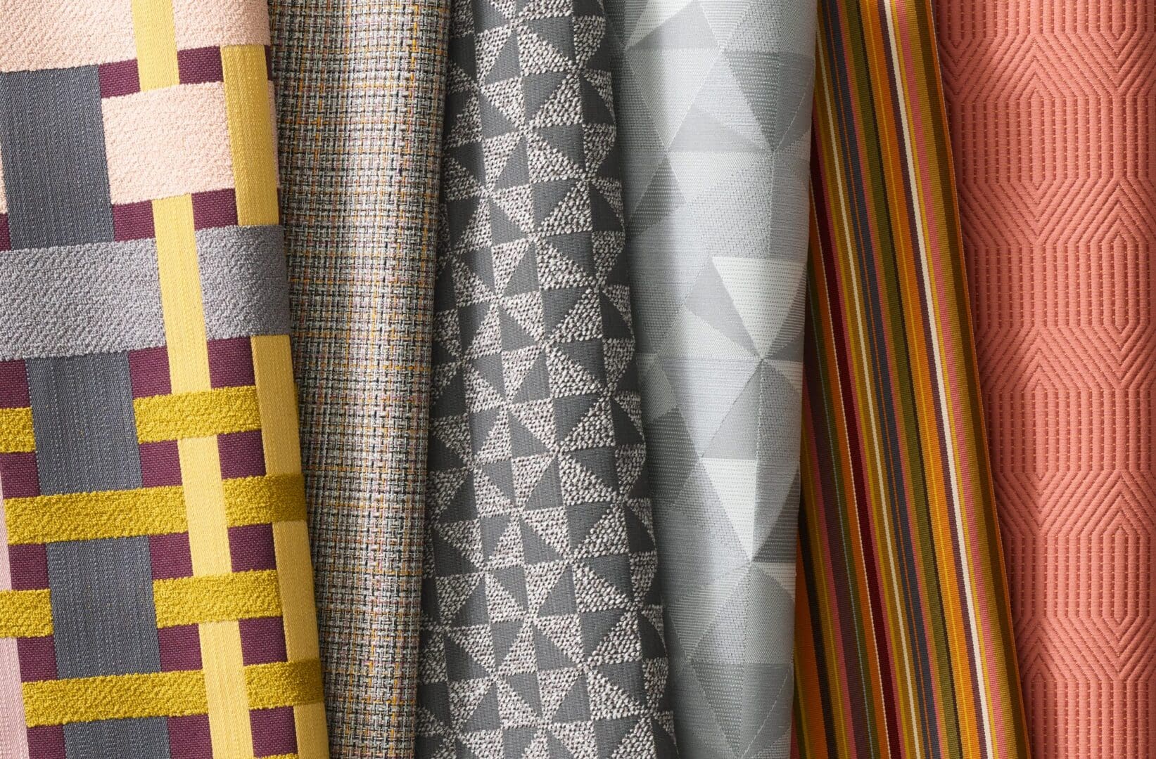 A close up of several different fabrics on display.