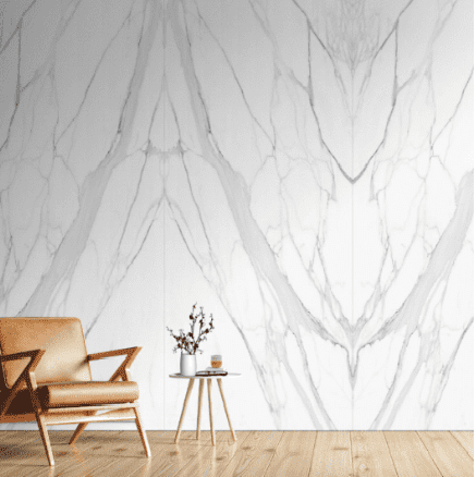 A chair and table in front of a wall with marble pattern.